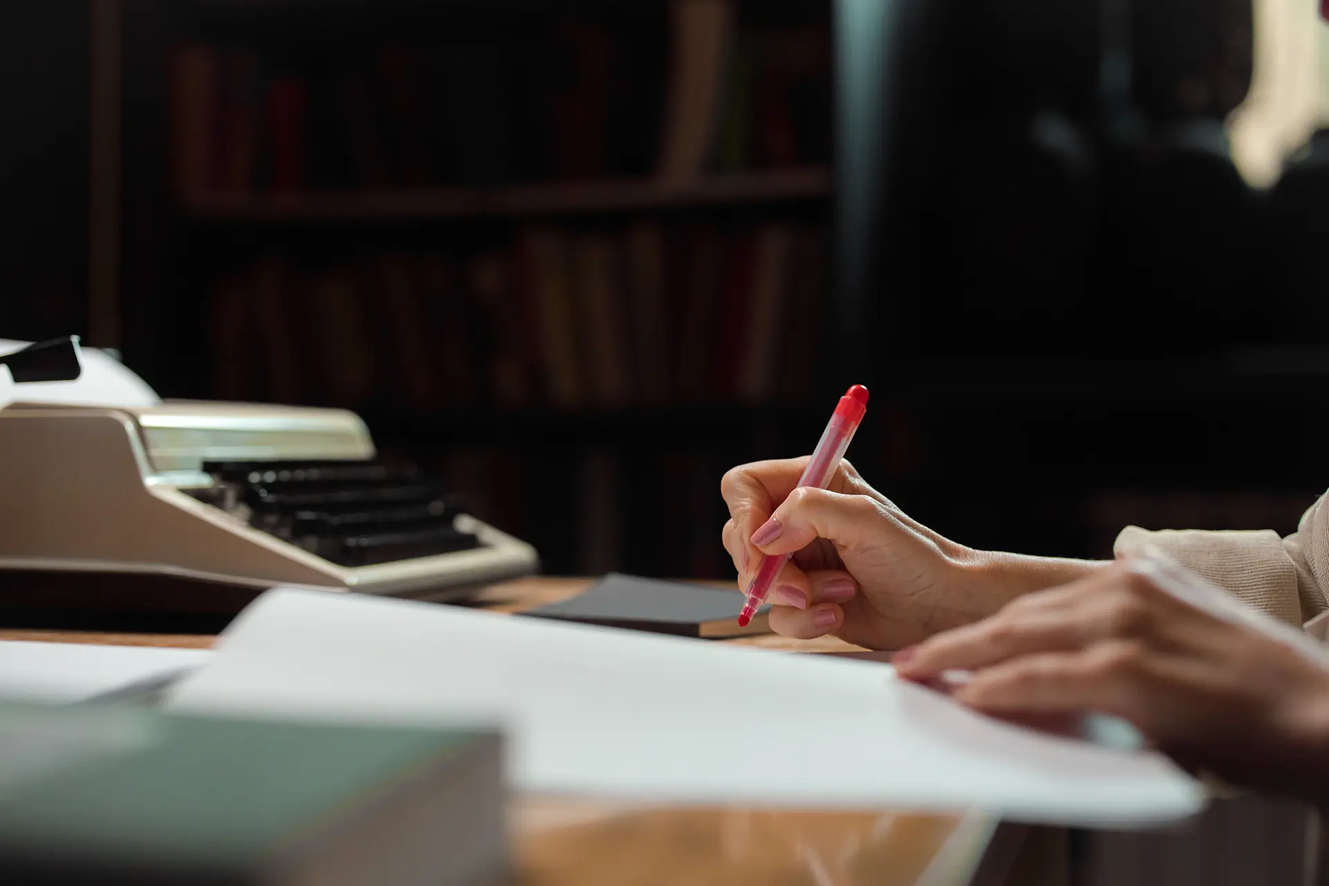 Writer editing a manuscript at a desk