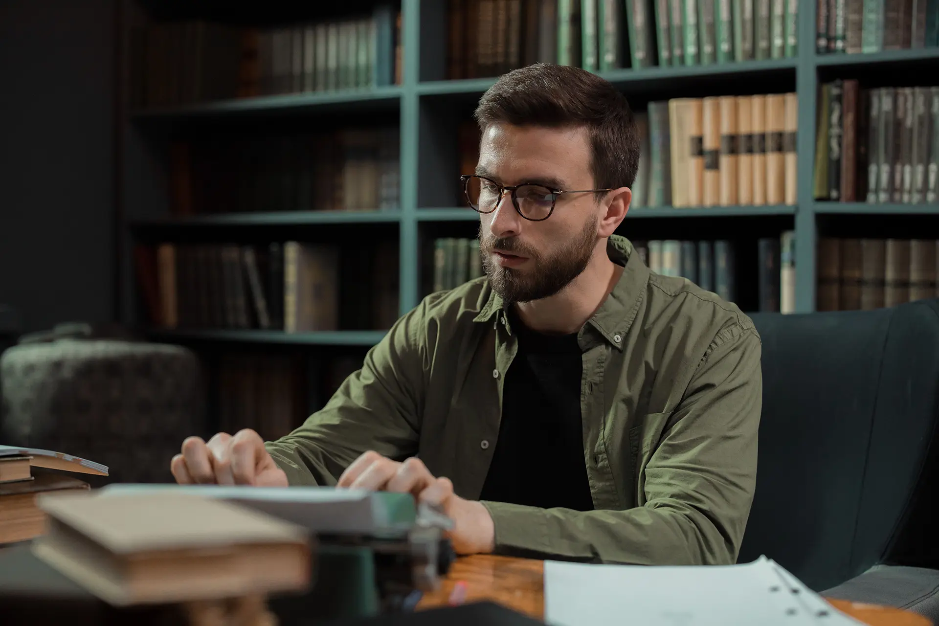 Person working on a book in a library